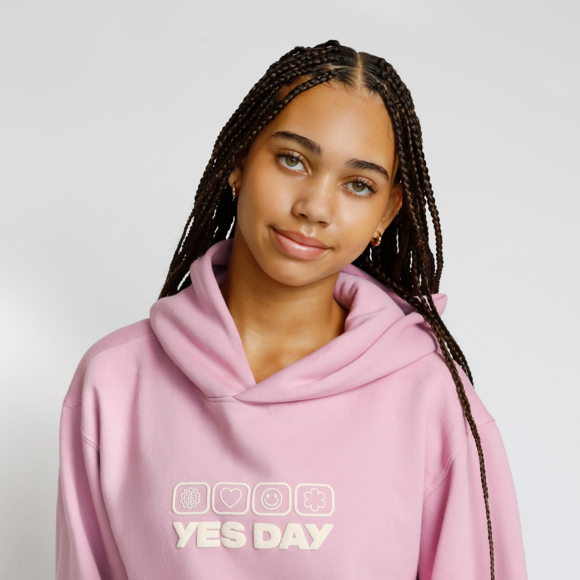 YES DAY founder Coco wearing a pink Good Feels Hoodie Sweatshirt with YES DAY logo.