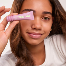 YES DAY teen founder Coco holding Lip Sweetie Lip Mask near her face.