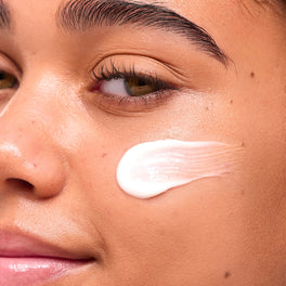 YES DAY founder Coco applying moisturizer to glowing skin—clean, effective hydration for all skin types and tones.